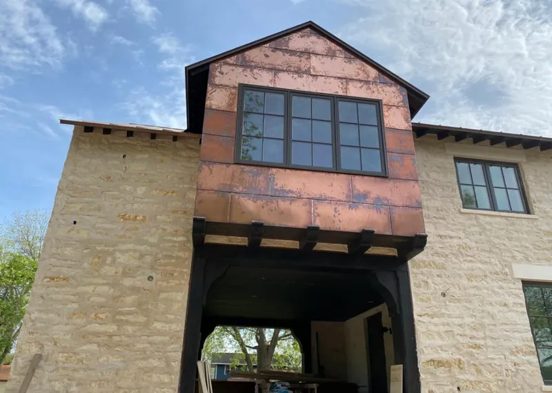 Copper metal panel facade on a stone building for Skylight Installation in Wanaque